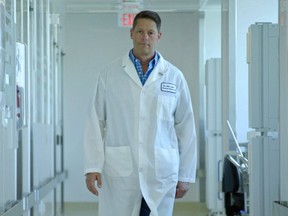 Owen Sound native John Lewis, the CEO of Entos Pharmaceuticals, walks to the lab.