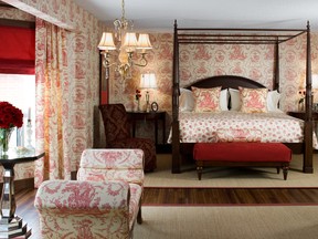 Colin and Justin layered in Toile de Jouy layers, ruby red window blinds and plump pillows to set pules racing in this boudoir. SUPPLIED