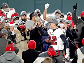 Tampa Bay Buccaneers quarterback Tom Brady celebrates with his teammates after beating the Green Bay Packers in the NFC championship game.