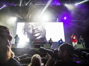 Overseen by a photo of deceased member Ol' Dirty Bastard, the Wu-Tang Clan perform at Bluefest in Ottawa, Ont. on July 13, 2019.