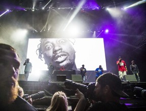 Overseen by a photo of deceased member Ol’ Dirty Bastard, the Wu-Tang Clan perform at Bluefest in Ottawa, Ont. on July 13, 2019.