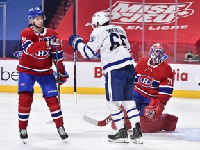 Jesperi Kotkaniemi #15 and goaltender Carey Price #31 of the Montreal Canadiens react as Ilya Mikheyev #65 of the Toronto Maple Leafs celebrates his goal during the third period at the Bell Centre on February 10, 2021 in Montreal.