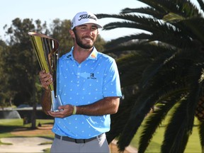 Max Homa of the United States poses with the trophy after defeating Tony Finau of the United States (not pictured) in a playoff to win The Genesis Invitational at Riviera Country Club