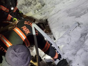 Members of the Schiller Park Fire Department help rescue a woman who was trapped for 10 hours under an awning.