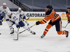 Maple Leafs' Zach Bogosian tries to block a shot by the  Oilers' Connor McDavid during Saturday's 4-0 Toronto win at Rogers Place, in Edmonton.