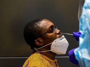 Kingsley Inyang is tested as passengers arrive at Toronto's Pearson airport after mandatory coronavirus disease (COVID-19) testing took effect for international arrivals on Feb. 1, 2021.