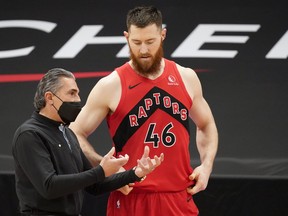 Toronto Raptors acting head coach Sergio Scariolo talks to centre Aron Baynes during Thursday's game.