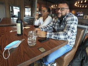 Matt MacInnis and Amelia Gray enjoy some wine at the State and Main Kitchen Bar restaurant at the Pickering Town Centre on Feb. 17, 2021.