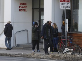 People congregate on Feb. 26, 2021 at the Bond Hotel in Toronto which has been converted to a homeless shelter  during the pandemic.