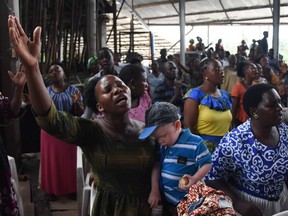 Believers attend Sunday mass without wearing masks and social distancing at Ufunuo na Uzima Church in Dar es Salaam on Feb. 7, 2021.  For more than six months, Tanzania has tried to convince the world it has been cured of the coronavirus through prayer.
