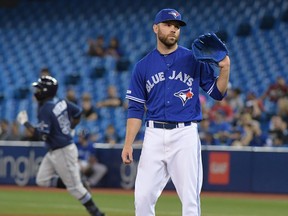 Blue Jays relief pitcher David Phelps (35) waits for a new ball as Tampa Bay Rays center fielder Guillermo Heredia (54) rounds the bases after hitting a two run home run in the eighth inning at Rogers Centre July 28, 2019.