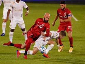 Toronto FC defender Laurent Ciman (26) works for the ball against Atlanta United forward Jon Gallagher (26) in the first half at Eazst Hartford, Conn.