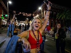 Fans celebrate in the streets of Ybor City in Tampa, FL after the Tampa Bay Buccaneers beat the Kansas City Chiefs in Super Bowl LV Feb. 7, 2021.