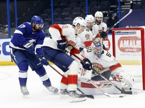Florida Panthers goaltender Chris Driedger (60) defends the puck from Tampa Bay Lightning left wing Alex Killorn (17) during the second period at Amalie Arena.
