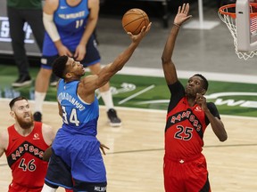 Bucks' Giannis Antetokounmpo goes to the rim while Raptors' Chris Boucher defends during the second quarter at Fiserv Forum on Thursday, Feb. 18, 2021. JEFF HANISCH/USA TODAY SPORTS
