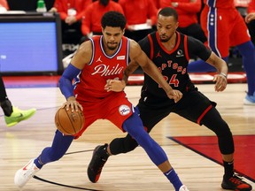 Philadelphia 76ers' Tobias Harris (left) drives to the basket as Raptors' Norman Powell defends during the first half at Amalie Arena on Tuesday, Feb. 23, 2021.