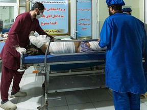 A wounded man receives medical treatment at the burns ward at a hospital in Herat on February 13, 2021 after dozens of fuel tankers caught fire in Islam Qala.