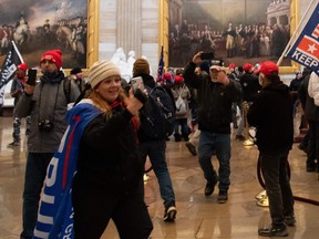 Jenny Cudd, left, and other supporters of U.S. President Donald Trump enter the Capitol's Rotunda on January 6, 2021, in Washington, D.C.