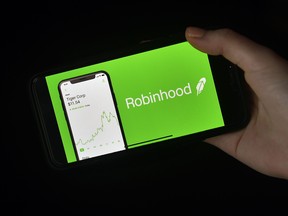 This photo illustration shows the logo of trading application Robinhood on a mobile phone in Arlington, Virginia on January 28, 2021.