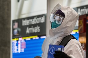 Heather Yen, arriving from Shanghai, awaits transportation to a quarantine hotel from Terminal 1 at Toronto Pearson International airport on Monday Feb. 22, 2021. ERNEST DOROSZUK/TORONTO SUN