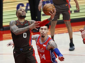 Portland Trail Blazers point guard Damian Lillard goes to the hoop against Philadelphia 76ers small forward Danny Green last week. Lillard deserves a spot in the all-star game, writes Ryan Wolstat.