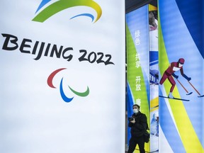 A journalist looks at a display at the exhibition centre for the Beijing 2022 Winter Olympics in Yaqing district, Beijing, China, Feb. 5, 2021.
