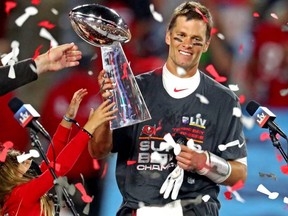 Tampa Bay Buccaneers quarterback Tom Brady (12) celebrates with the Vince Lombardi Trophy after beating the Kansas City Chiefs in Super Bowl LV at Raymond James Stadium.