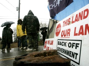 Six Nations protesters stand outside a barricade in Caledonia, Ont., near Hamilton in 2006.