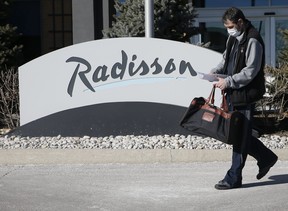 Steve Duesing holds his release papers and waits for an Uber to take him home after he was quarantined at the government-approved Radisson Hotel on Dixon Rd., February 3, 2021.