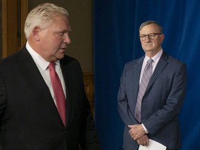 Premier Doug Ford, left, and Dr. David Williams, Ontario's Chief Medical Officer, attend a news conference at the Ontario Legislature in Toronto on Wednesday, November 25, 2020.