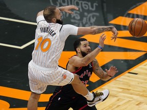 Raptors guard Fred VanVleet (right) deflects a pass by Orlando Magic guard Evan Fournier during their game on Tuesday, Feb. 2, 2021 in Tampa, Fla.