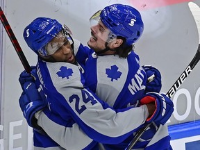 Toronto Maple Leafs right wing Wayne Simmonds (24) celebrates his goal against the Vancouver Canucks with teammate Auston Matthews (34) during first period NHL hockey action in Toronto on Saturday, February 6, 2021.