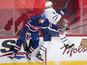 Toronto Maple Leafs' Jake Muzzin (8) collides with Montreal Canadiens' Josh Anderson during third period NHL hockey action in Montreal, Saturday, February 20, 2021.