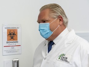 Premier Doug Ford tours a lab at the Ontario Institute for Cancer Research to see COVID-19 research in Toronto on Tuesday, February 23, 2021.