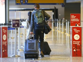 Passengers arrive at the International Airport from Cancun in Calgary on Monday, Feb. 1, 2021.