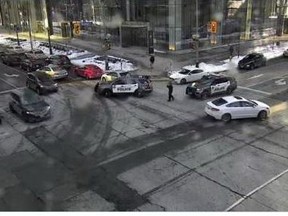 Toronto Police closed off the intersection at York St. and Lake Shore Blvd. after reports of bottles being thrown from a condo balcony on Sunday, Feb. 22, 2021.