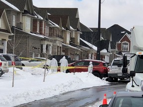 Investigators are pictured at a Mount Albert home where a man was shot by police after a woman was fatally stabbed. Three others -- a woman and two children -- were wounded.