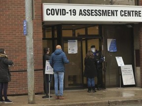 People line up to get tested at the COVID Assessment centre located at Toronto Western Hospital at Bathurst St. and Dundas St. West on Jan. 3, 2021.