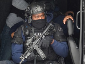 Members of a SWAT team deploy in a residential neighbourhood after two police officers were shot in Dallas, February 18, 2021.