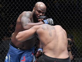 In this UFC handout, Derrick Lewis, left, punches Curtis Blaydes in a heavyweight bout during the UFC Fight Night event at UFC APEX on Feb. 20, 2021 in Las Vegas, Nevada.