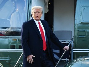 In this file photo taken Jan. 20, 2021, outgoing U.S. President Donald Trump boards Marine One at the White House in Washington, D.C.