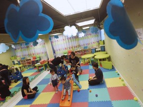 Children play before taking part in a specialized class preparing toddlers for kindergarten interviews in Hong Kong.