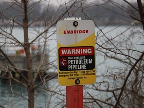 A sign marks where an Enbridge pipeline lands in St. Clair Township after crossing the St. Clair River, south of Sarnia, Ont., Feb. 19, 2021.