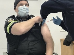 A Peel Paramedics member receives a COVID-19 vaccine.