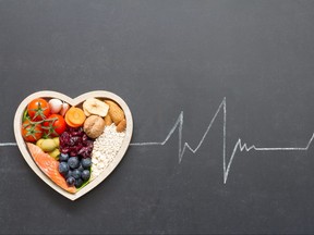 Healthy food in heart and cardiograph on blackboard medical abstract