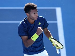 Felix Auger-Aliassime of Canada celebrates after winning match point in his Men's Singles semifinal match against Corentin Moutet of France at the ATP 250 Murray River Open at Melbourne Park in Melbourne, Australia, Saturday, Feb. 6, 2021.