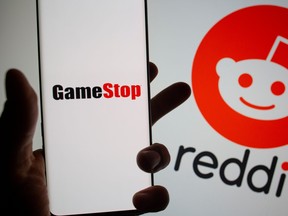 GameStop logo is seen in front of displayed Reddit logo in this illustration.