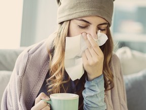 Young woman suffering from cold.