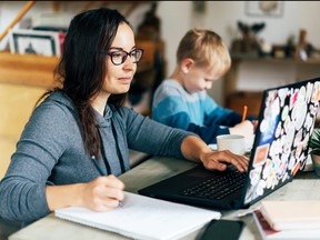 A mother works from home in this photo illustration.