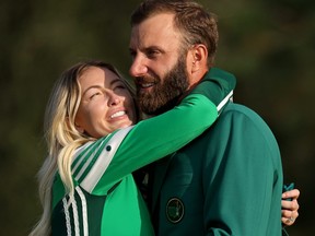Dustin Johnson of the United States celebrates with fiancee Paulina Gretzky during the Green Jacket Ceremony after winning the Masters at Augusta National Golf Club on Nov. 15, 2020 in Augusta, Ga.